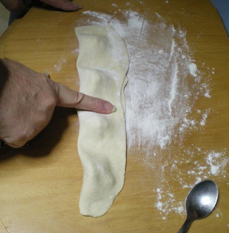 Pressing bourekia with finger image