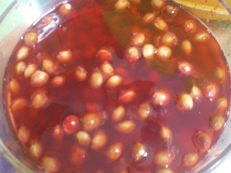 Sour cherry pits in a bowl with water image