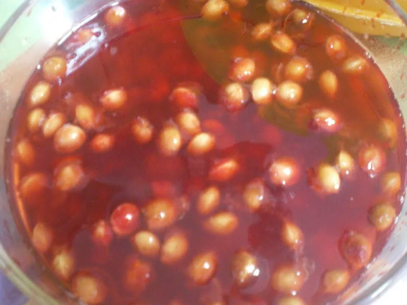 Sour cherry pits in a bowl with water image