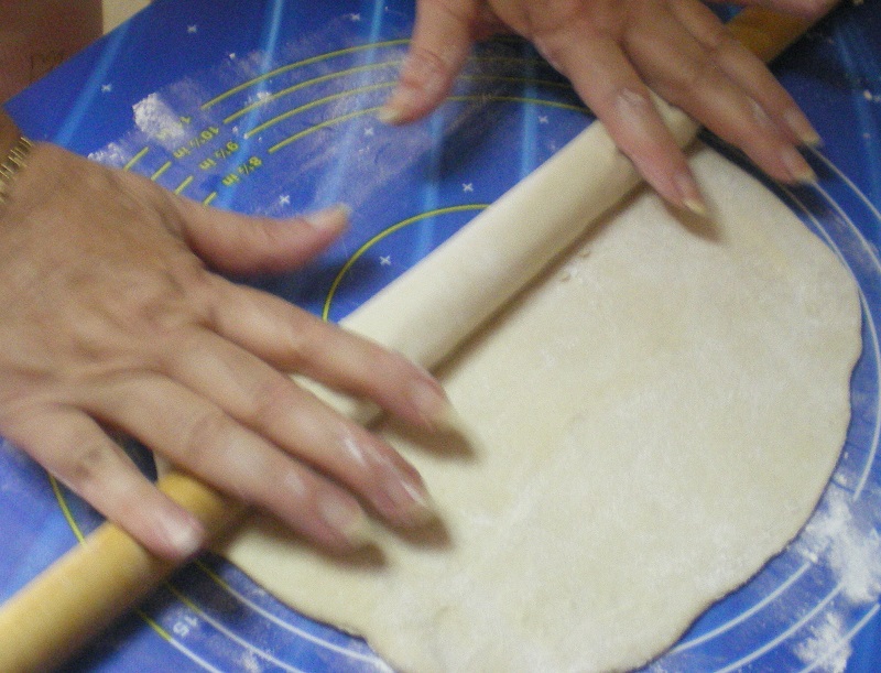 rolling dough by hand image