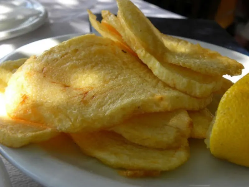 round slices of fried potatoes patates tiganites image