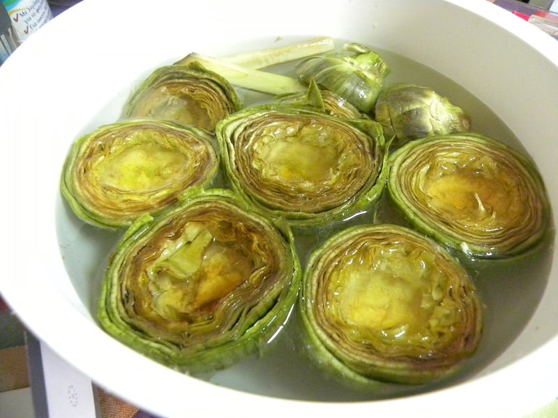 Artichokes in a bowl with water and lemon juice image