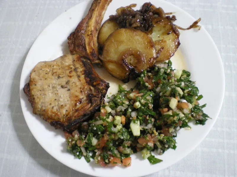 Pork chop served with tambouli image