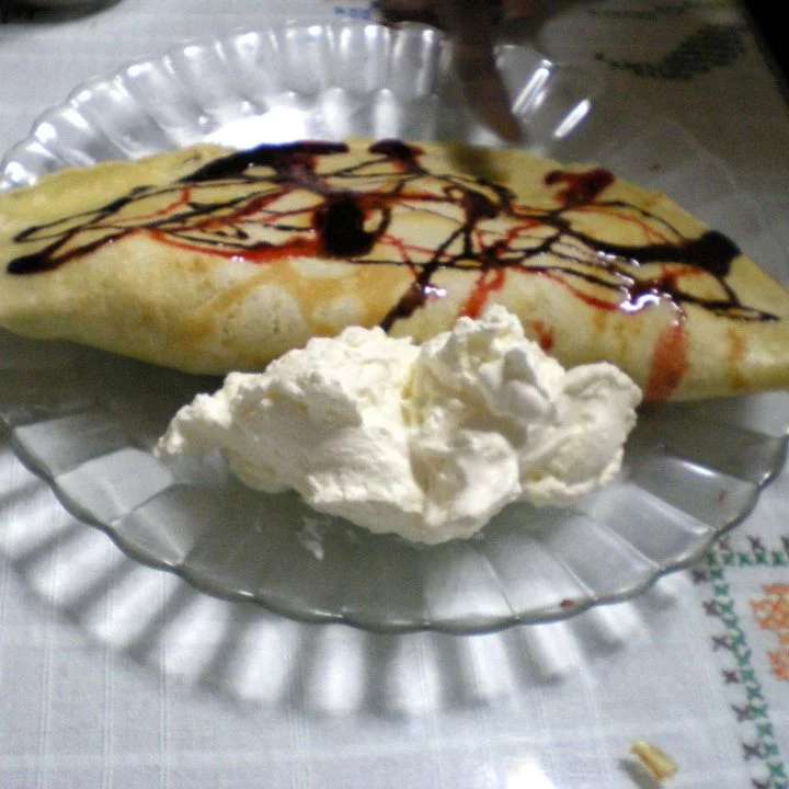 crepe with sauce and whipped cream picture