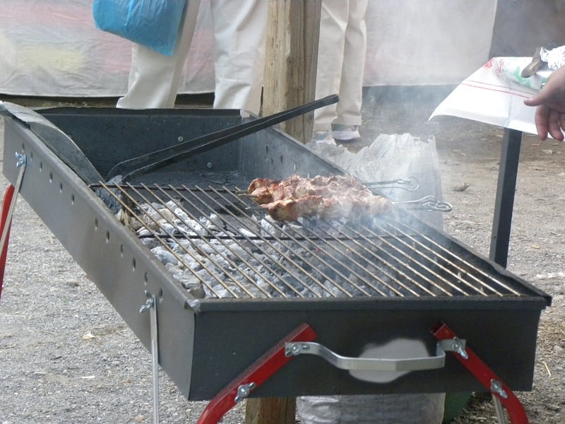 grilling pork souvlakia image