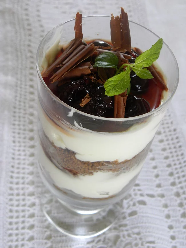 cheesecake with sour cherries in a glass image