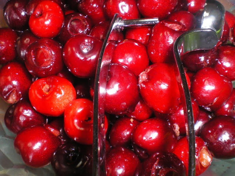 cherries with a cherry pitter image