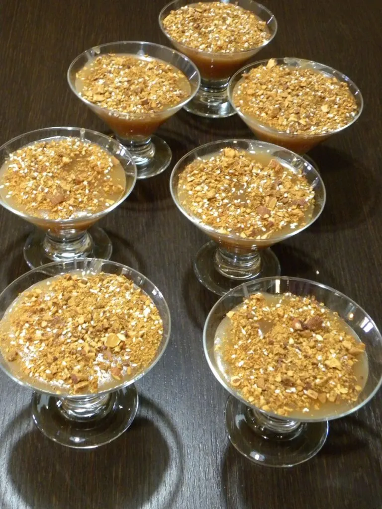 Moustalevria served in bowls with nuts on top image