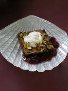 Brownies with whipped cream and framboise sauce image
