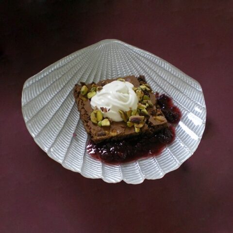 Brownies with whipped cream and framboise sauce image