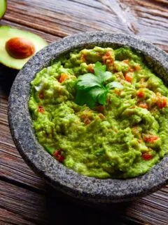 Guacamole with avocados served image