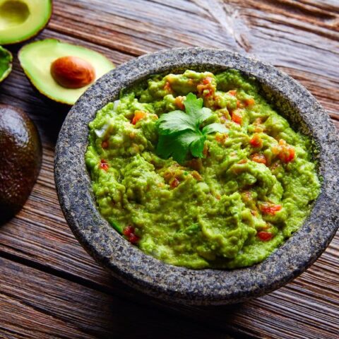 Guacamole with avocados served image