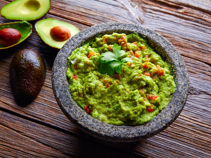 Guacamole with avocados served image