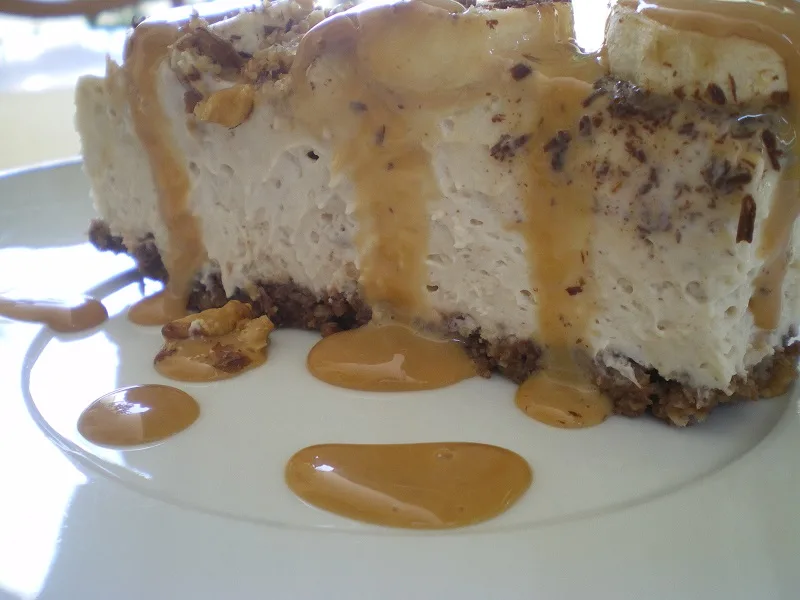 A slice of Banoffee cheesecake with sauce image