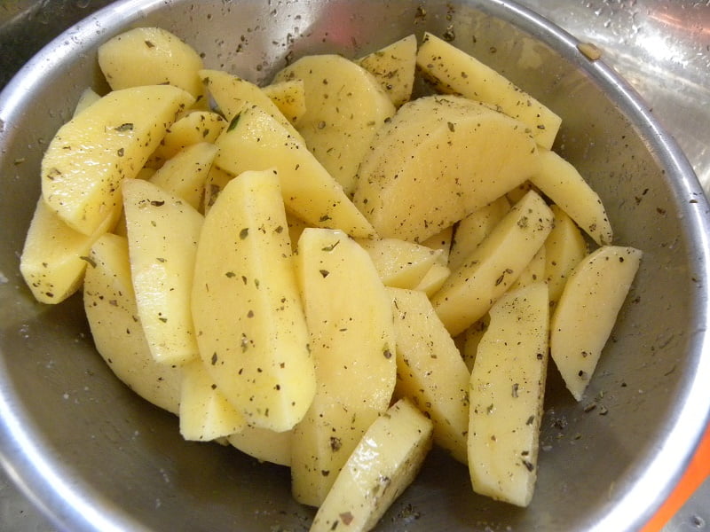Potato wedges seasoned with salt pepper and oregano image