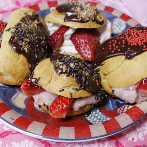 Eclairs with chocolate and strawberries image