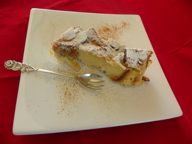 A slice of Tsoureki pudding with icing sugar image