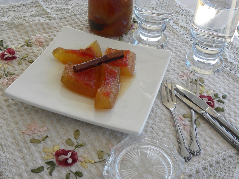 Glyko karpouzi preserve in a plate with a cinnamon stick on top image