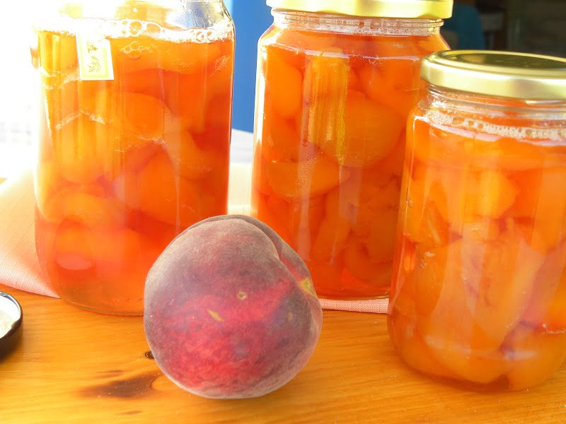 peaches in jars and raw peaches photo