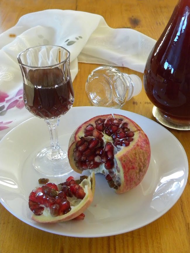 Pomegranate Liqueur in a glass and bottle image