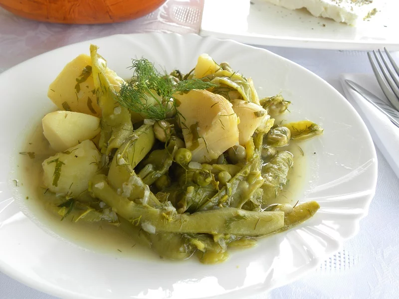 Fava beans koukia with potatoes artichokes and peas image