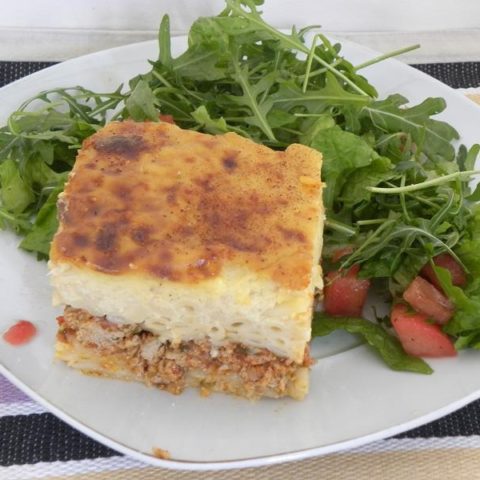 A slice of Pastitsio with salad photo