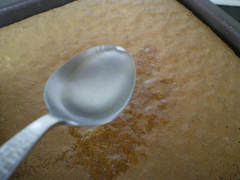 Revani adding syrup to the sponge image