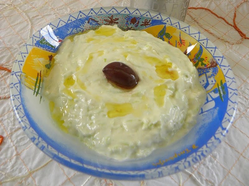 tzatziki in a bowl with an olive in the centre image
