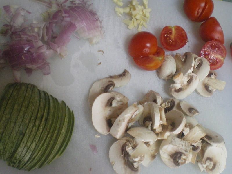 Chopped vegetables onion garlic zucchini mushrooms cherry tomatoes image