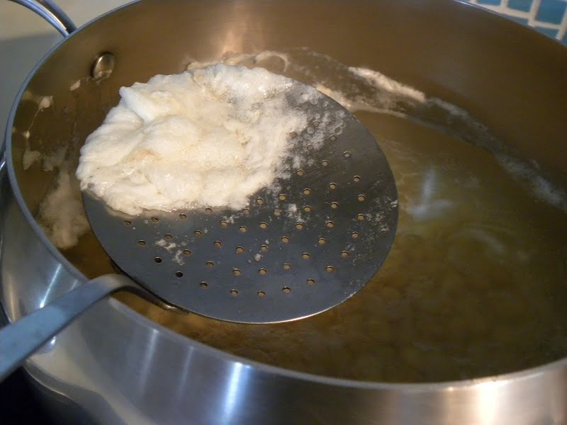 Skimming off foam from chickpeas image