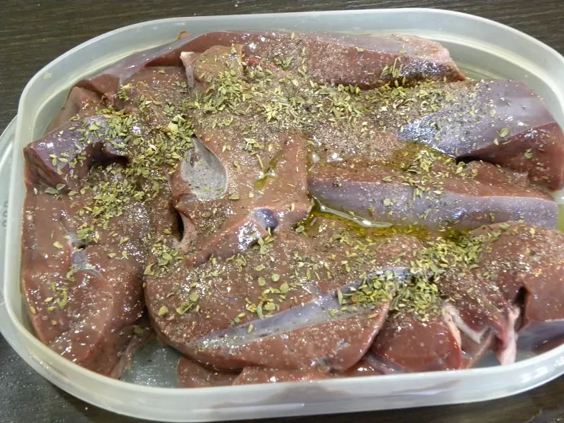 Seasoning the calf liver image