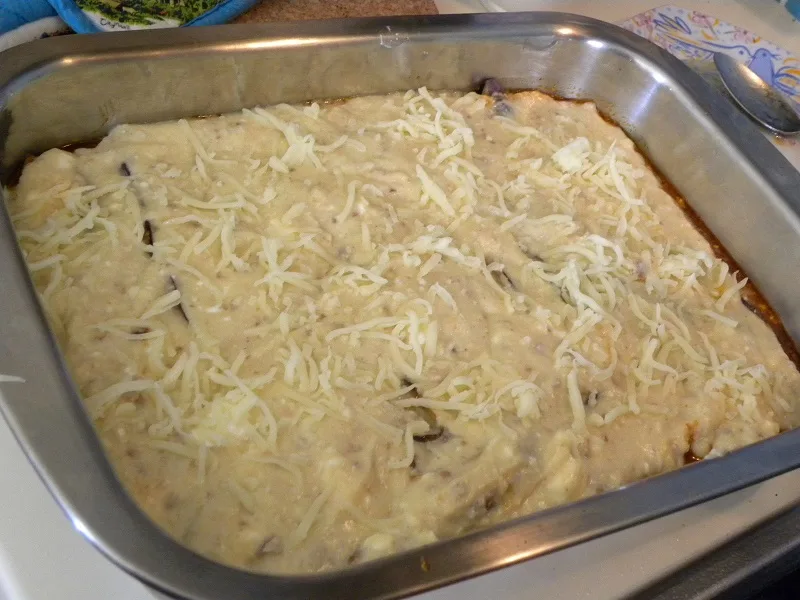 Adding bechamel on top of vegetarian moussakas image