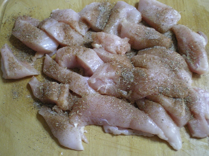 spices on top of chicken breast image