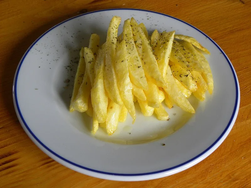 Fried potatoes with extra salt an oregano image