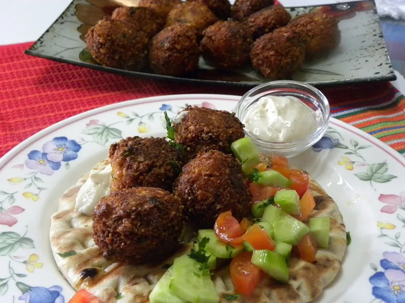 Falafel with salad and tahini on a pita bread image