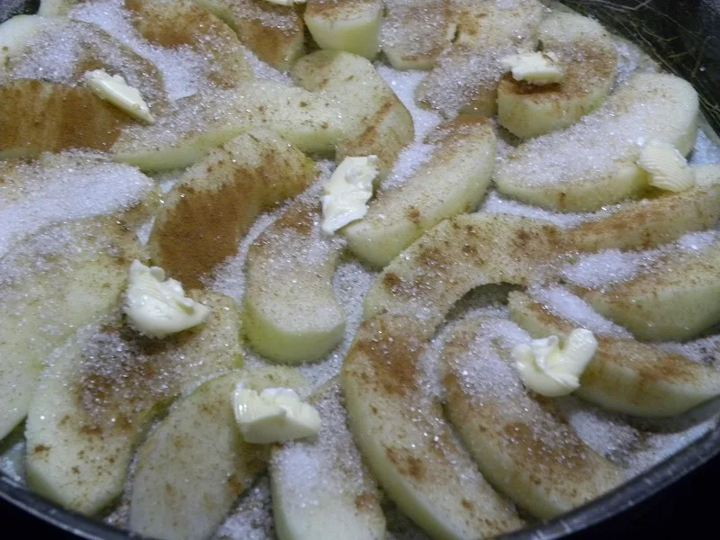 Arranging the apples with cinnamon sugar and butter image