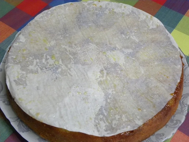 Removing the parchment paper from the cake image