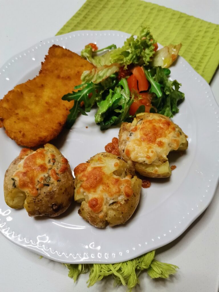 Smashed potatoes with schnitzel and salad image