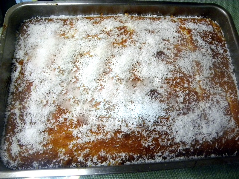 Revani sprinkled with coconut after pouring the syrup image