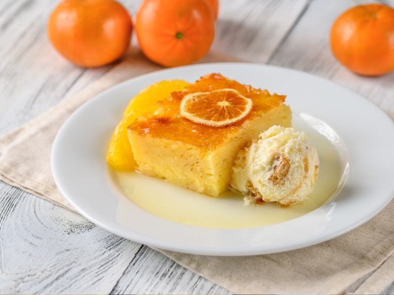 A piece of portokalopita with ice cream image