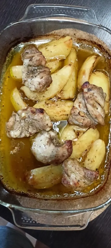 chicken thighs with roasted potatoes in a Pyrex dish image