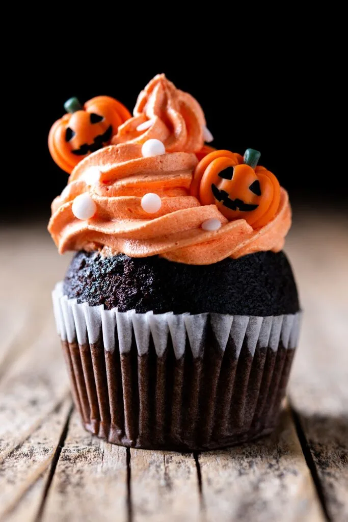 Chocolate cupcake with orange frosting and decorations image
