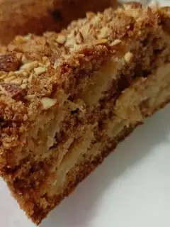 Piece of olive oil apple cake with almonds image