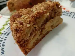 Piece of olive oil apple cake with almonds image