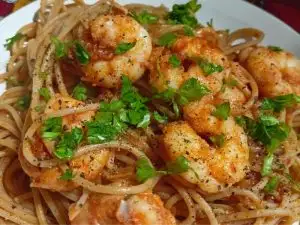 Garidomakaronada served with parsley on top image