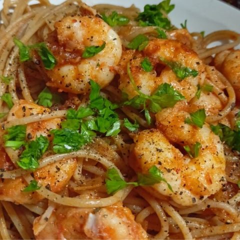 Garidomakaronada served with parsley on top image