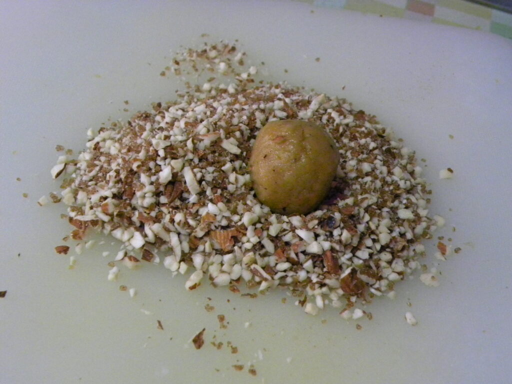 Thumbrint cookies rolled in almonds image